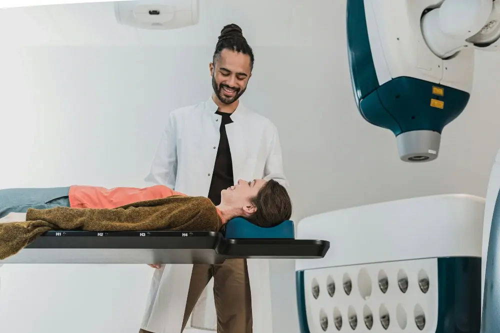 A young doctor helping a patient get ready fora procedure